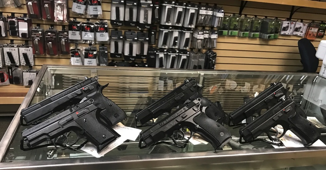 Handguns displayed in a glass counter at Coyote Point Armory